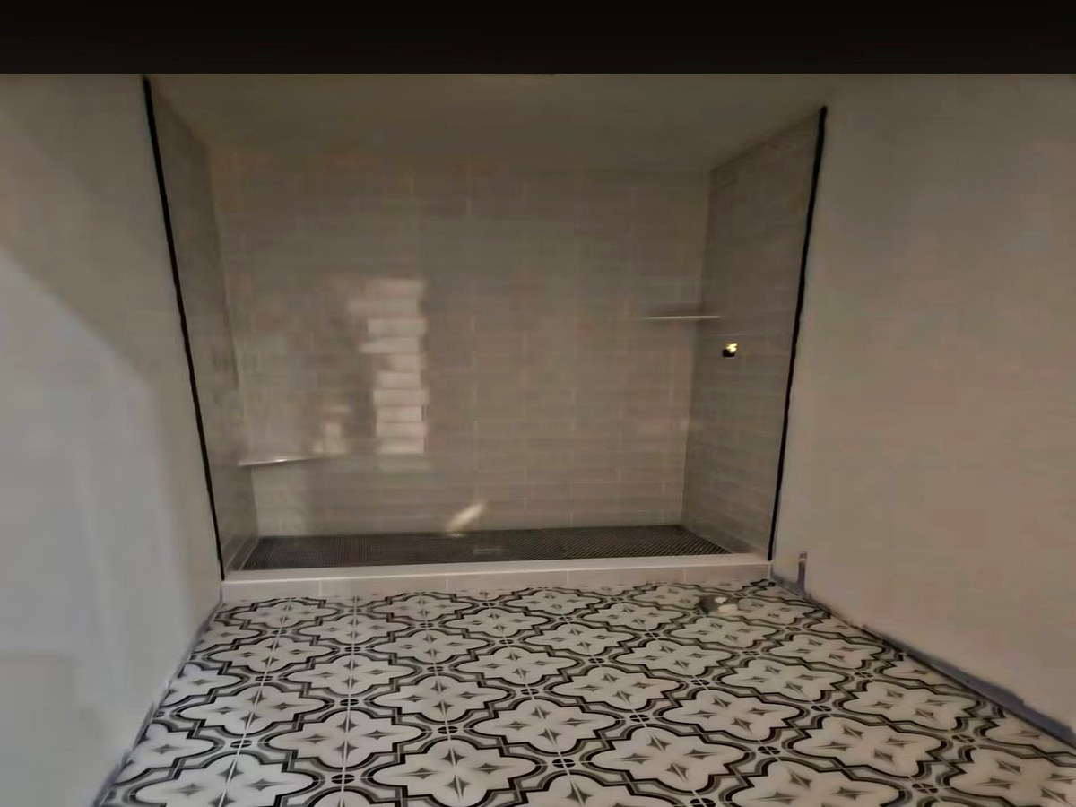 Decorative Patterned Floor & Frameless Shower