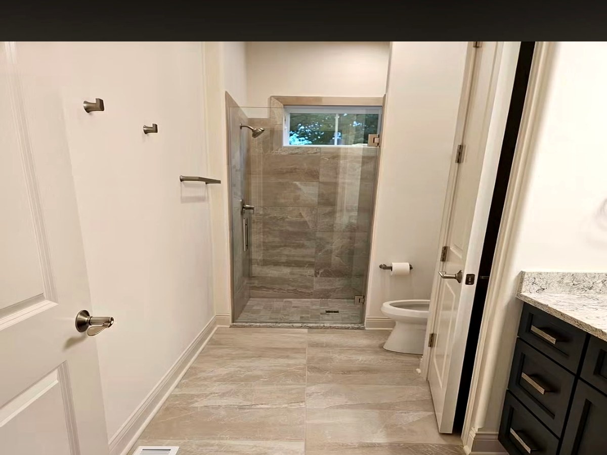 Taupe Tile Floor & Glass Shower
